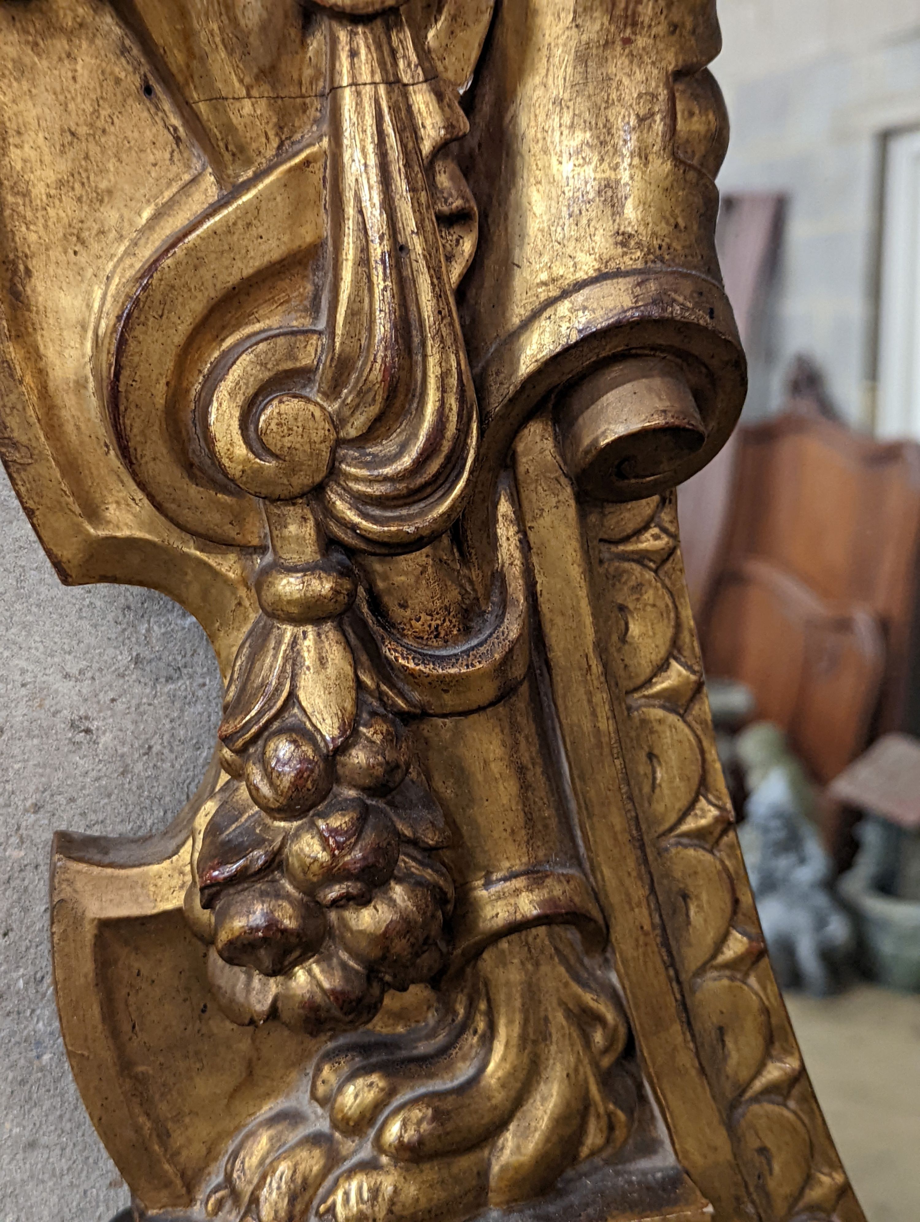 A Victorian carved giltwood oval wall mirror decorated with cherubs and C scrolls., width 74cm, height 110cm